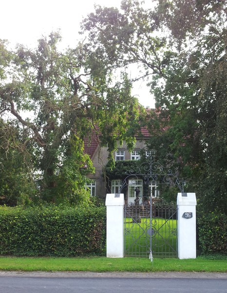 Altes Haus mit Tor und Statue